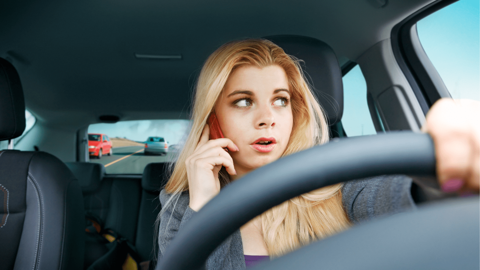 Girl driving a car having phone call(opens