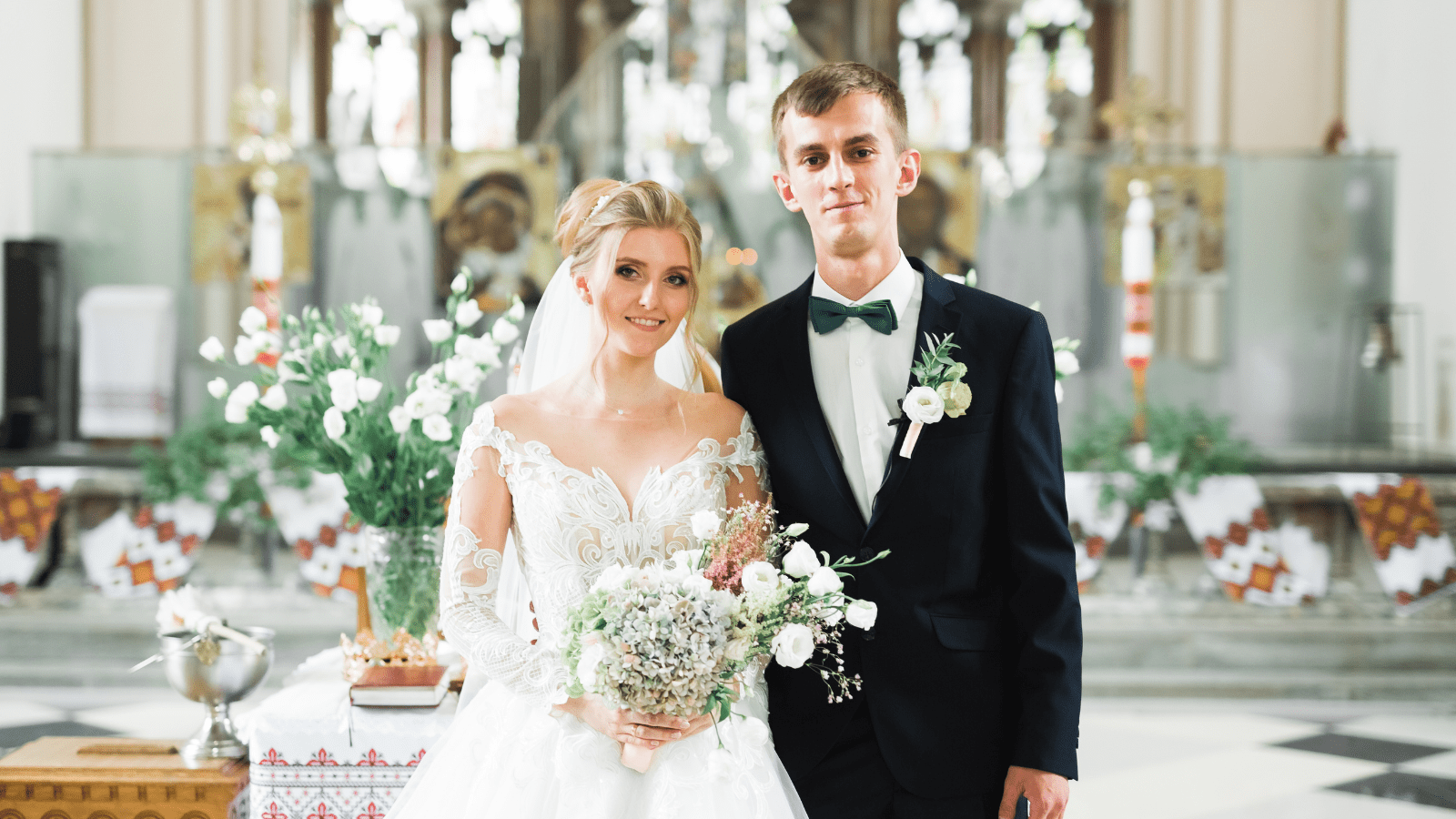 Married couple posing in a church after ceremony.