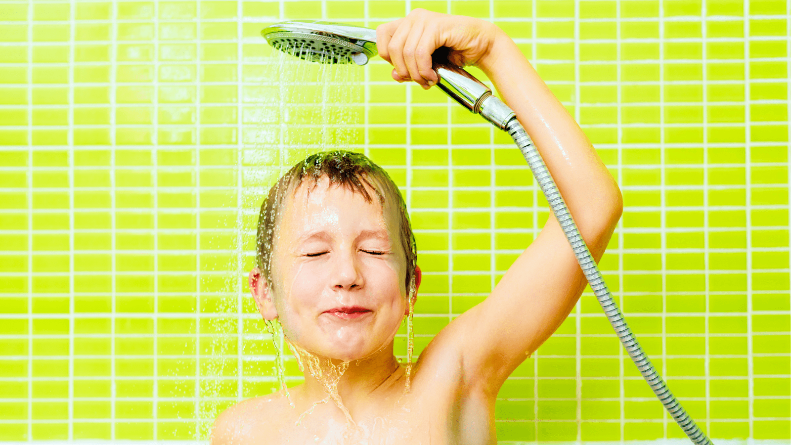 Boy in the Bathtub Washes His Head with Water Sprayed from the S