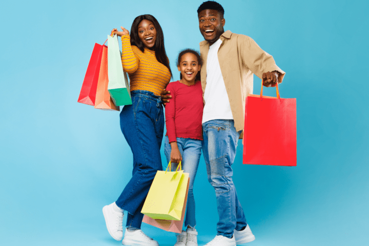 African American woman, man and girl posing with shopping bags